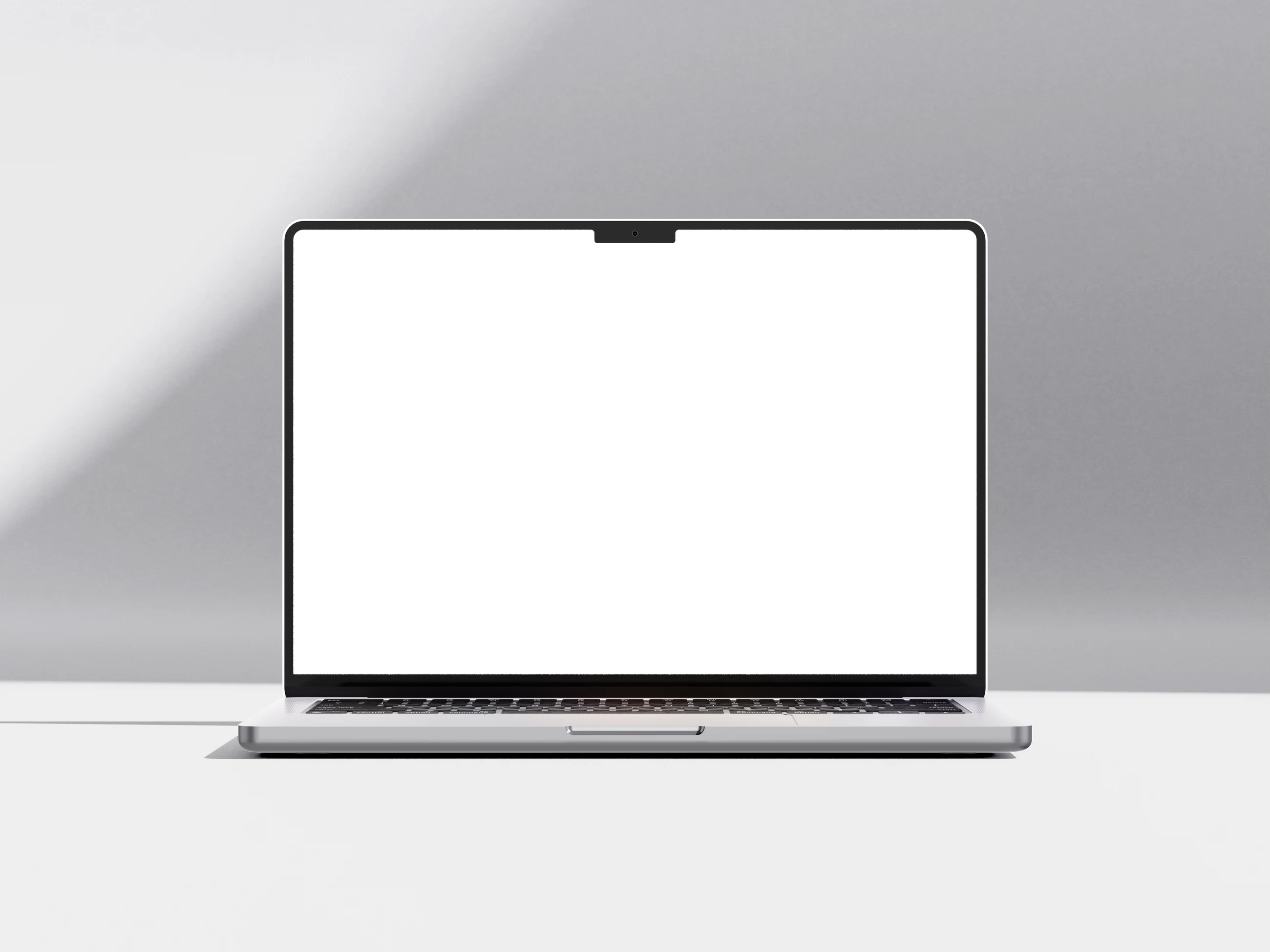 Laptop showing the Fintree website on a glass shelf in a light grey studio