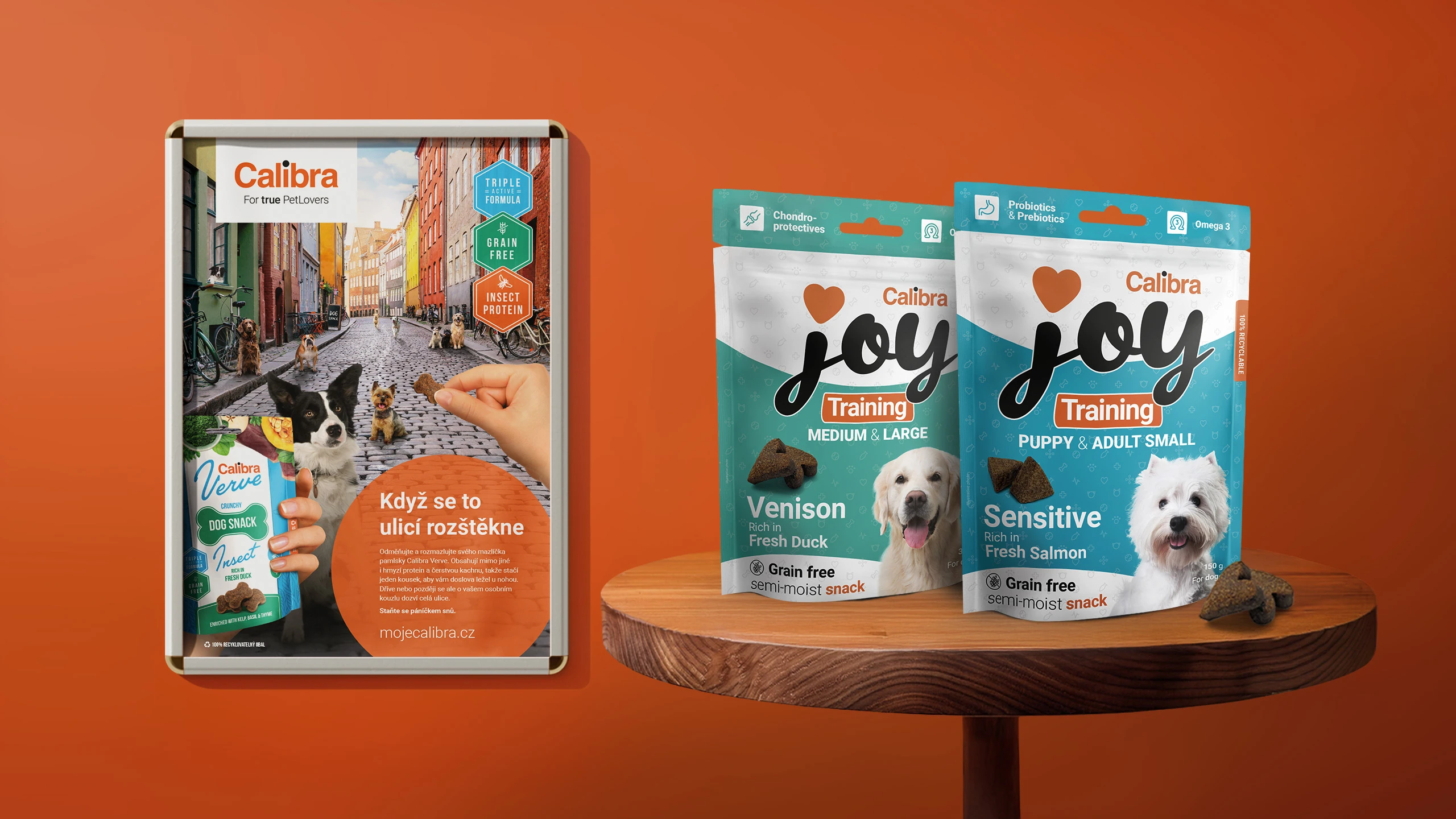 Orange wall with Calibra pet food posters and packaging on a table